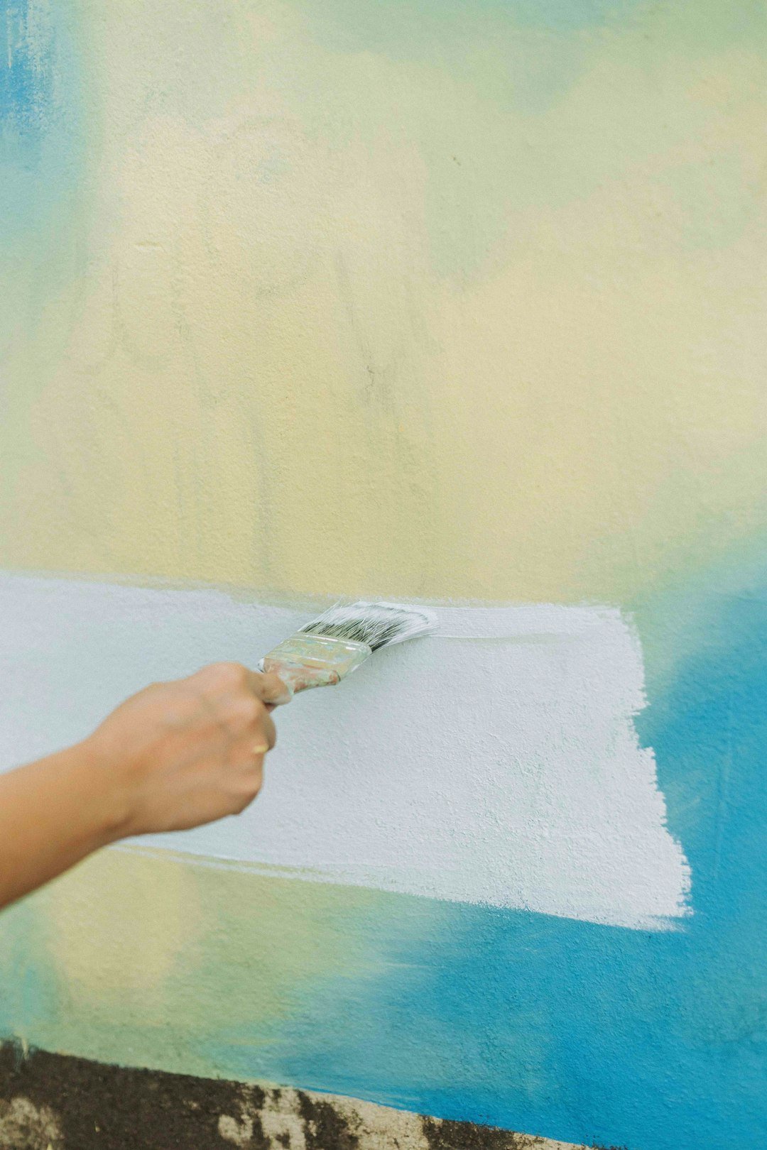 Home a-person-painting-a-wall-with-a-paint-roller-ifk-pzkybas